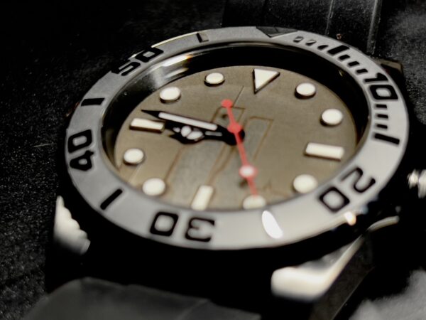 A close up of the Black Ops watch face on a dark background