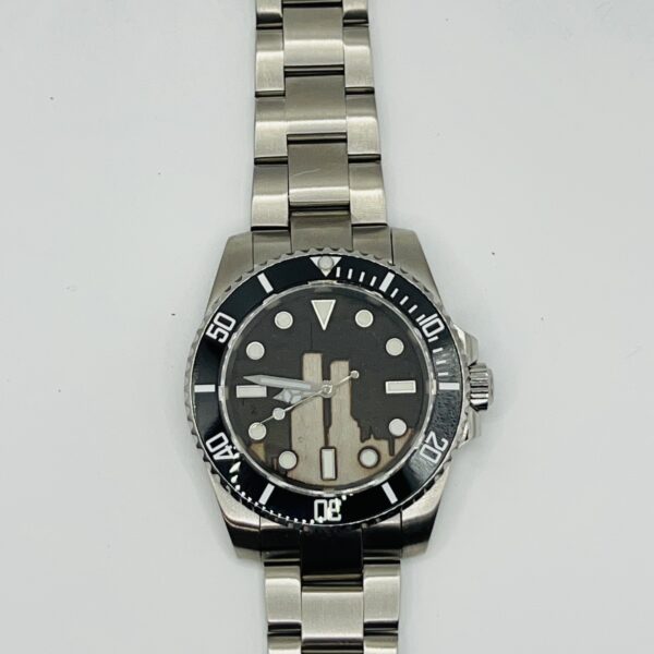 A close up of the Stainless Steel watch face on a white background